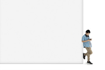 Preteen schoolboy leaning on the wall