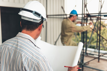 Construction Engineer is Inspection Scaffolding Installation Before Constructing Civil Work at Site While Checking on Engineering Drawing Together. Supervisor and Contractor Worker Execution Inspected