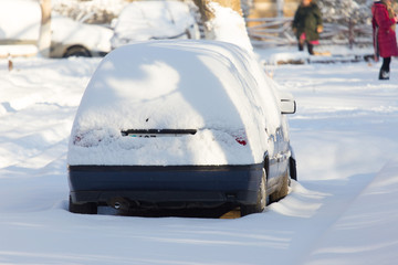 Car under the snow in the city