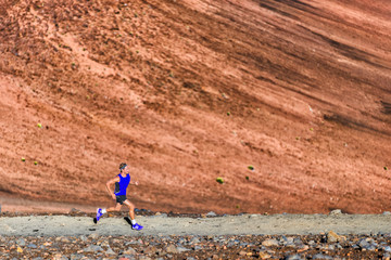 Run running fit athlete runner man doing sport exercise in nature. Ultra trail run athlete training on path in volcano mountain landscape background.