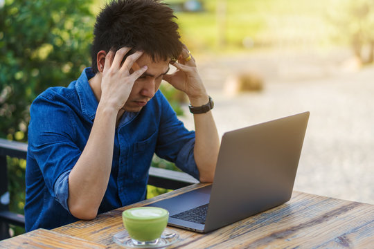 stressed man using laptop computer