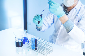 Scientist with equipment holding tools during scientific experiment science concept