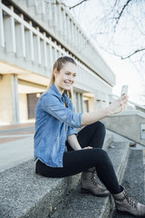young woman in the city taking a selfie