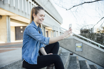 Woman in her twenties taking a selfie or videocalling