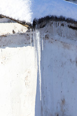 Frozen water flowing from drain or sanitary pipe in winter season: A photo for icy background