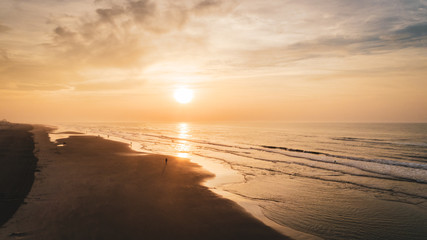 Beach Sunrise over Ocean and waves with cloudy purple yellow orange sky Aerial at New Jersey Shore