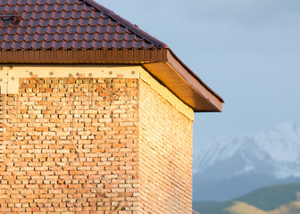 unfinished house and a roof against the blue sky.