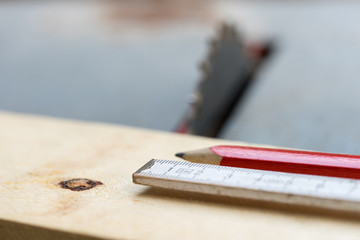 Circular saw with pencil and folding rule to measure