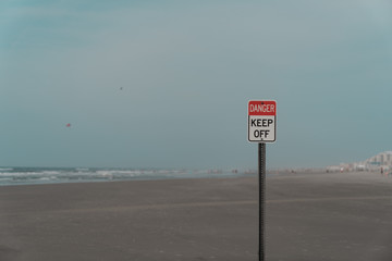 Danger Keep off Sign with Blue Cloudy Sky and New Jersey Beach in the Background