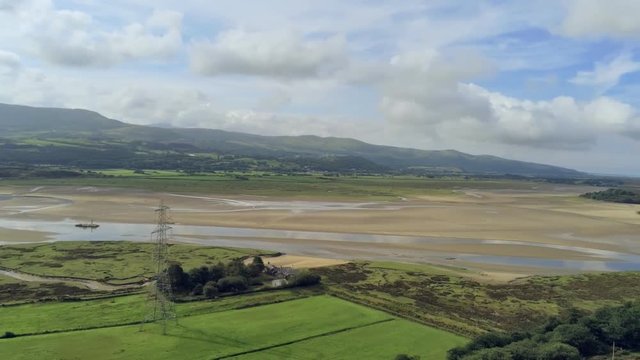 Aerial view, pan move. Drone panorama of sea bay during low tide in Wales