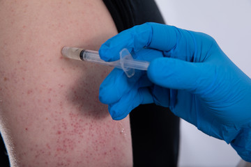 vaccination serum is being injected into your arm