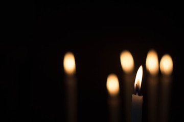 candle burning brightly on bokeh background.