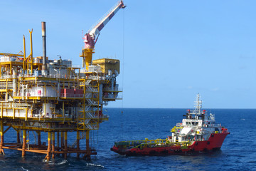 Supply boat transfer cargo to oil and gas industry and moving cargo from the boat to the platform
