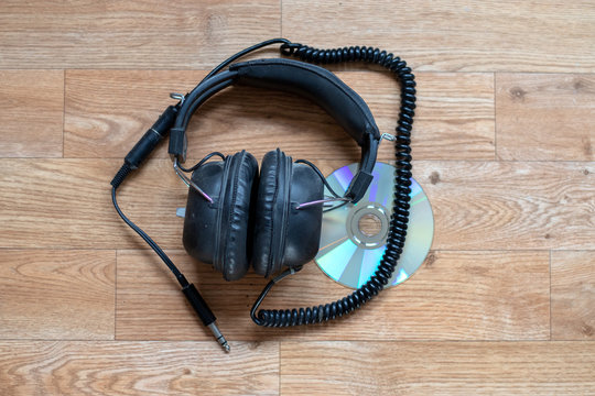 Old Vintage Headphones On Top Of A CD