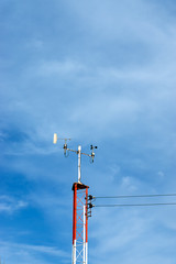 Obraz premium Poles equipped with marine weather monitoring equipment with sky background.