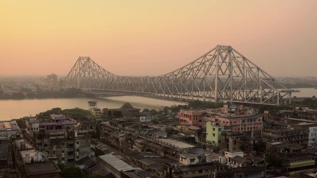 Beautiful sunset view of Kolkata city with a Howrah bridge on the Ganga river, West Bengal, India.