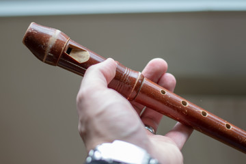 Brown old flute holding in the hand of a man © Markus