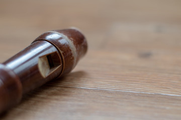 Close up view of the top of a wooden flute