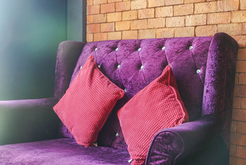 close up luxury velvet violet sofa with red cushion for seat