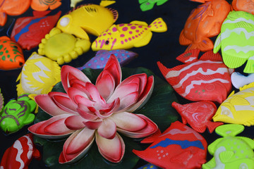 Multicolored artificial fish for children's fishing in an amusement park