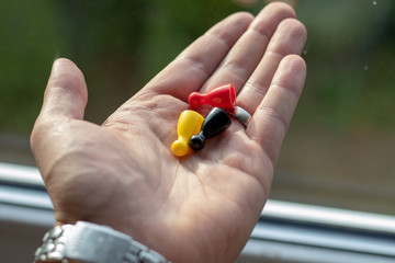 Group of different tokens in the hand of a man