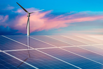 Wind turbines and solar panels closeup on sky background