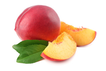 Nectarine with green leaf and slices isolated on white background.