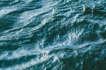 Top view of stormy sea. Blue water backround.