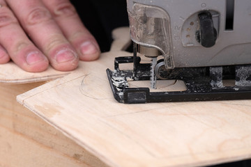 metalwork workshop of work on cutting of difficult forms of wood an electric jigsaw