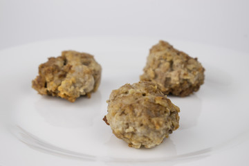 Fried homemade patties on a white plate.