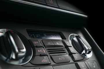 Fototapeta na wymiar Air conditioning button inside a car. Climate control AC unit in the new car. Modern car interior details. Car detailing.