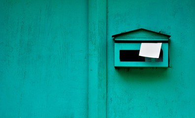 green mailbox at old wood door