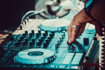 DJ plays and mix music on digital midi mixer controller