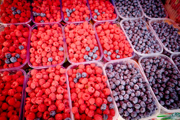 Berry fruits in baskets at a marketplace. mixed berries at eco market