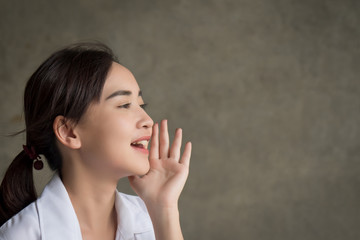 happy woman shouting screaming with upset mood; portrait of happy smiling asian woman shouting or screaming to blank space; harsh and loud noise shouting communication concept; asian adult woman model