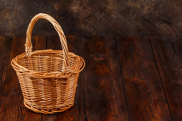 Empty wicker basket on wooden background with copyspace