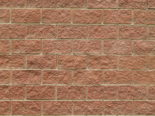 Wall from pink stone blocks, background