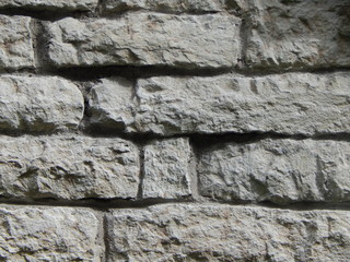 Wall of gray rough stone, background