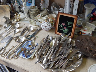 Collections of vintage items on the flea market: tableware, porcelain figurines, candlesticks