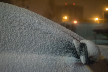 A car in the snow at night.