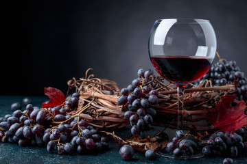 Glass of red wine and grapes.
