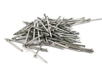 A pile of small furniture nails on a white background. Isolated.