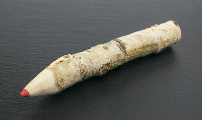 Pencil of wood on a black background.