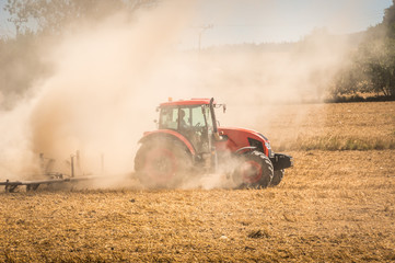 Tractor plows a field - agriculture and agronomy concept