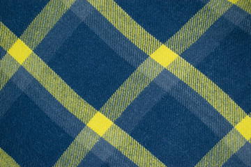 Background of dark blue and yellow squared cloth.
