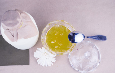 Milk in a bottle and honey in a cup.