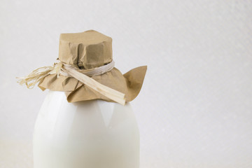 A bottle of natural milk on a light background.