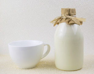 A bottle of natural milk on a light background.