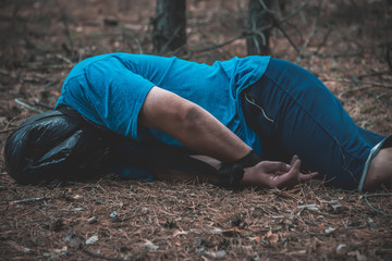 corpse of a man in the woods