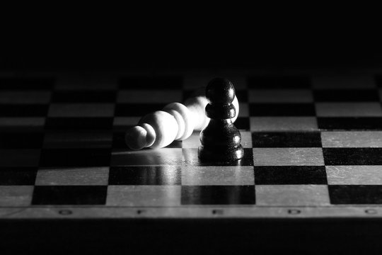 Composition with chessmen in the glossy chessboard